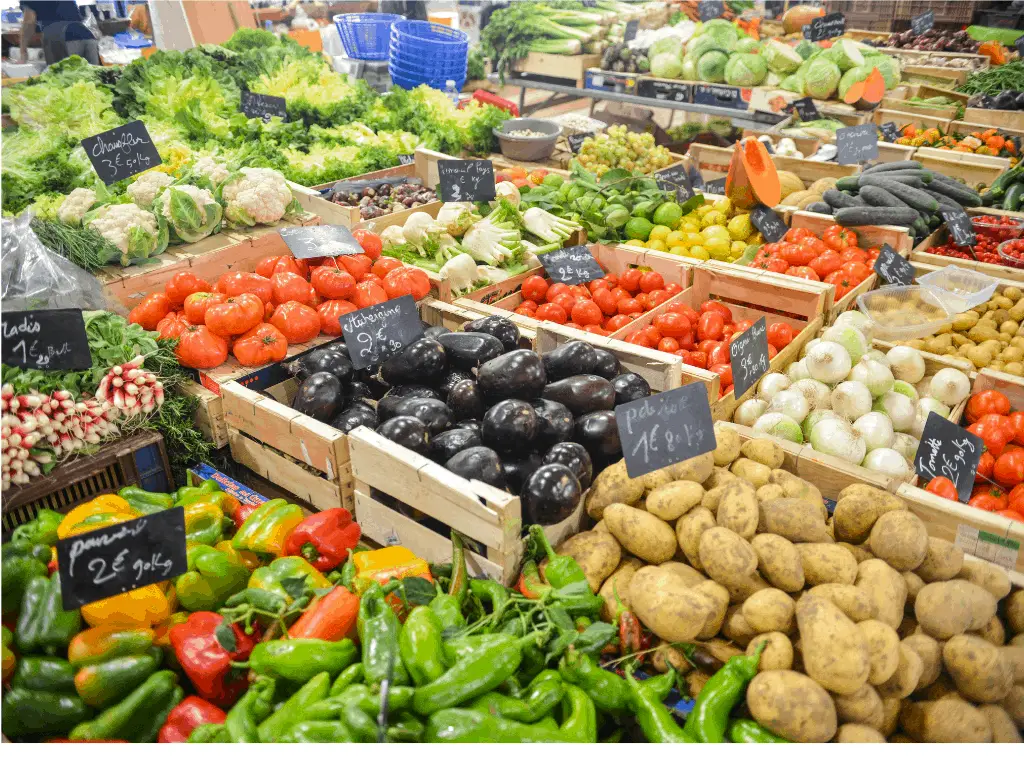 Plentiful vegetables and fruits in wooden crates at a market