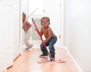 Young boy cleaning the floor