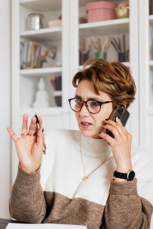 Worried woman on the phone - credit card scam